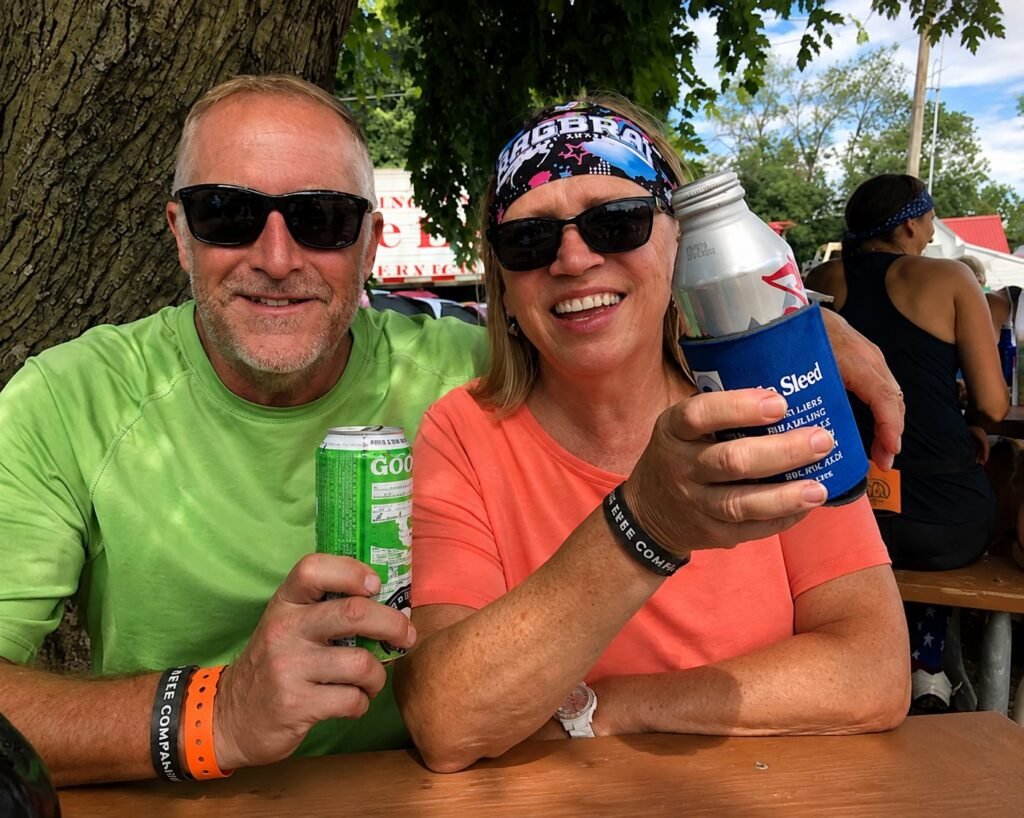 Kelly and Rita smiling and holding drinks at RAGBRAI, Iowa